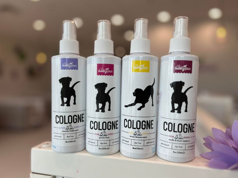 four dog cologne bottles